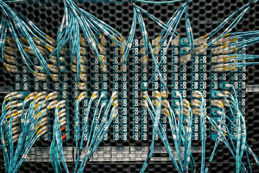 Close-up of color-coded fiber optic cables in a data center.